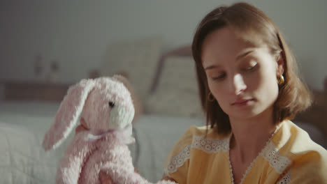 a girl playing with dolls in her room