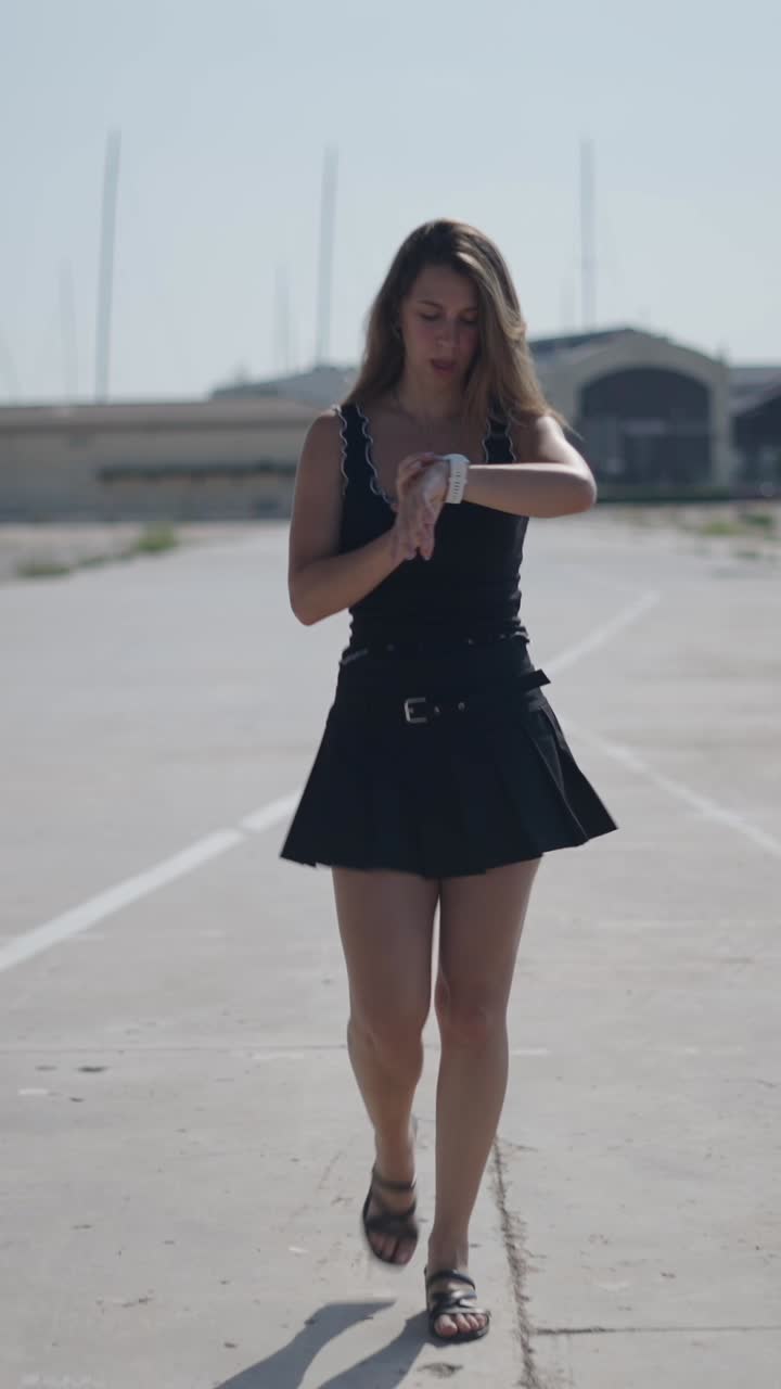 Woman checking her watch outdoors