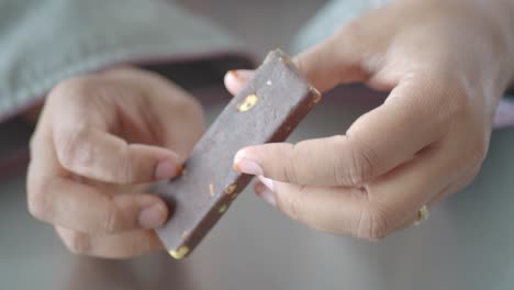 closeup of a hand holding a chocolate bar