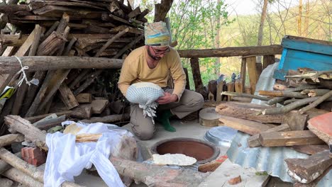 prepare bread from sour dough kneading wheat flour ingredient in rural village local people push dough to make it ready to put flat bread in oven to bake hot wood fire bread smell nice wonderful taste