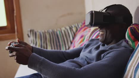 african american man wearing vr headset at home