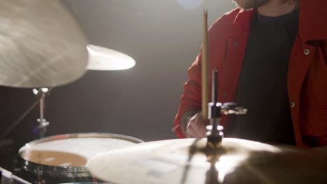 drummer playing drums at music studio while rehearsing