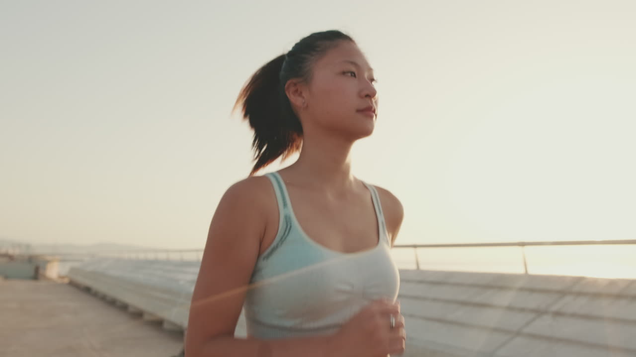 Woman running outdoors in sunlight