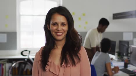 portrait of caucasian businesswoman smiling and standing in office