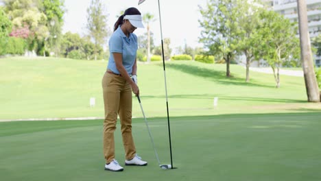 Woman-golfer-about-to-sink-her-putt