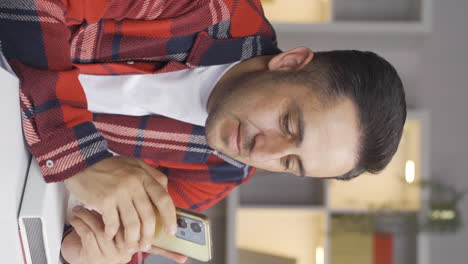 vertical video of longingly the man looks at the photo on the phone.