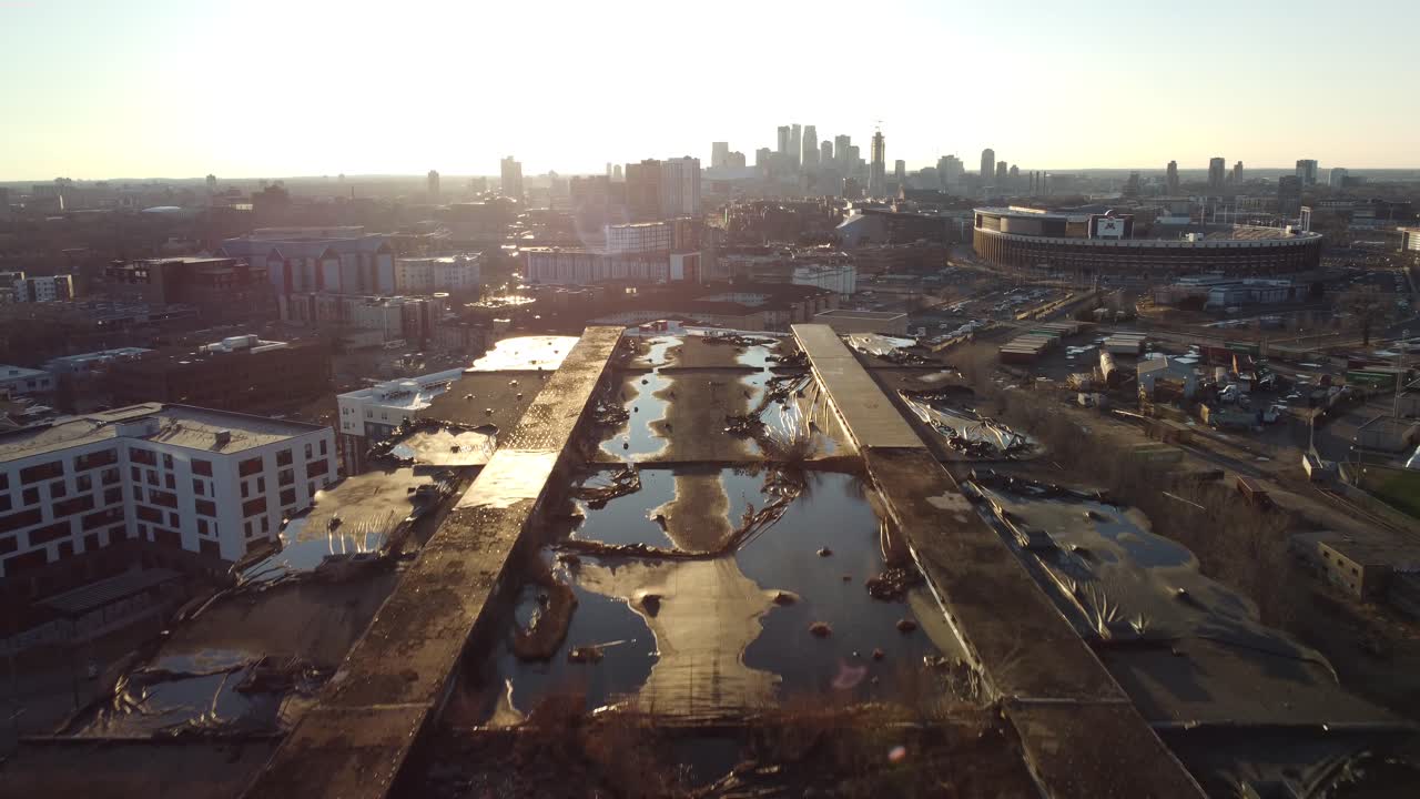 Drone threading needle through abandoned industrial towers in Minneapolis, MN during Golden Hour