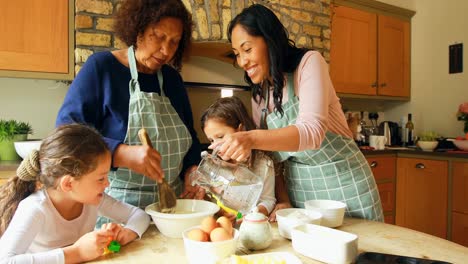 Siblings-preparing-food-with-family-in-kitchen-4k