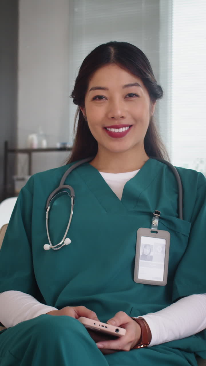 Female Asian Nurse Looking at Camera at Clinic