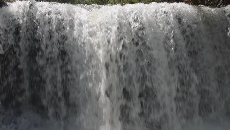 water cascades over the edge of a waterfall in owen sound, canada, on a sunny day