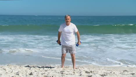 aged man working his muscles with dumbbells