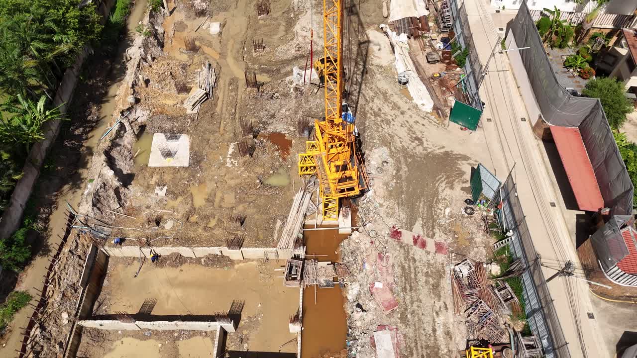 Aerial View of an Active Construction Site with Workers and Foundations