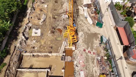 aerial view of an active construction site with workers and foundations