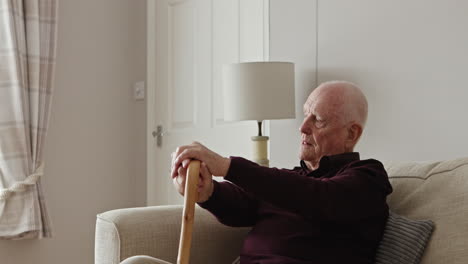 elderly man sitting on sofa at home