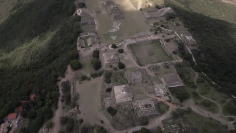 aerial tilt view of partly excavated mesoamerican ruins in oaxaca, mx