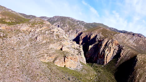 rugged gorge with ancient rock formations in langeberg mountains, aerial tilt-up