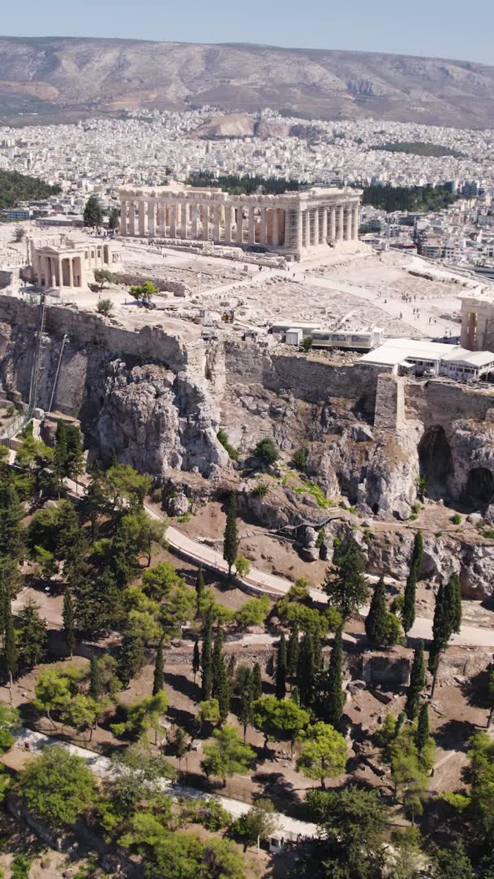 Timeless ancient Acropolis rising above Athens cityscape, vertical aerial