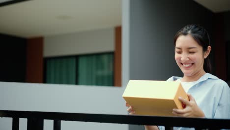 beautiful young woman receiving parcel from blue uniform delivery man f the house with good service from shopping online. courier man delivering a cardboard box postal package to destination.