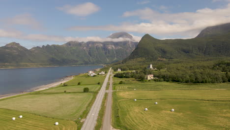 Farm-Landscape-Of-Village-Of-Mevik-With-Rural-Road-And-Mevik-Chapel-In-Gildeskal,-Norway