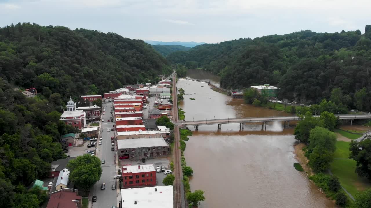 Aerial View of a River Town Nestled in the Mountains