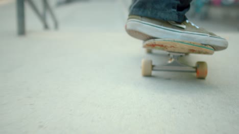 skateboarder rolling down ramp at skatepark