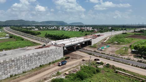 drone footage of the serene landscapes of amaravathi, vijayawada, with a road cutting through.