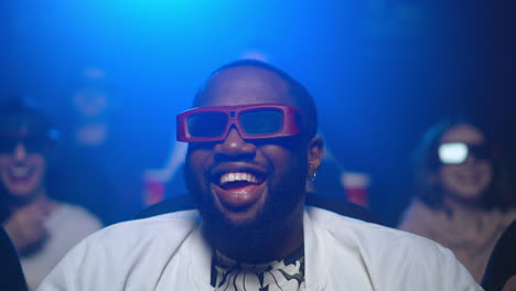 happy african man laughing in cinema