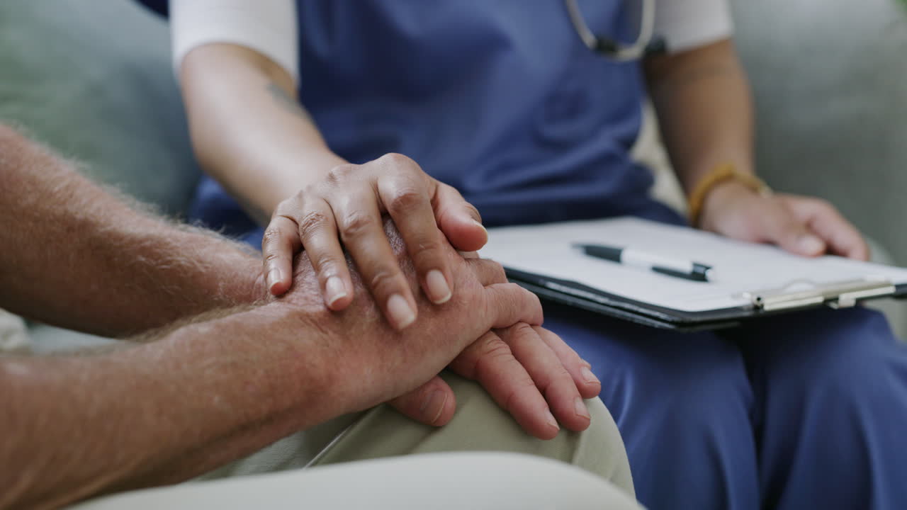 Nurse comforting an elderly patient