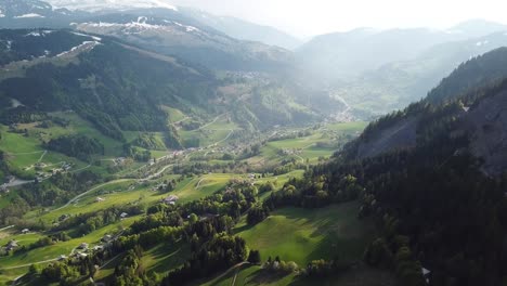 french alps village in valley on sunny day, aerial view