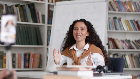 online class/presentation with woman teacher in library