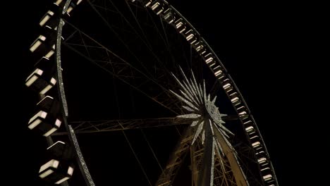 the budapest hungary - drone flying over a large illuminated ferris wheel during nighttime - close up shot