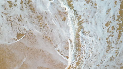Slow-motion-of-splashing-sea-waves-wetting-the-beach-sand