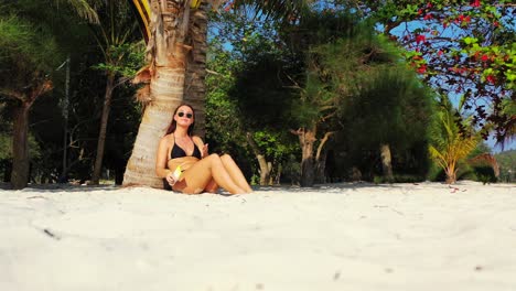 young woman sunbathe and puts sunscreen on her body, protecting from dangerous radiation of tropical sunlight in bali
