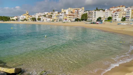 Platja-de-les-Barques-sea-field-Maresme-Barcelona-Mediterranean-coast-plane-close-to-turquoise-blue-transparent-water-beach-without-people