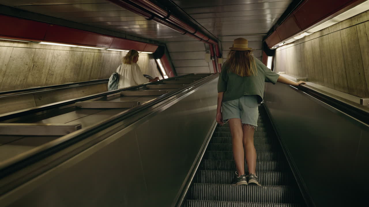 People on Escalators in a Subway