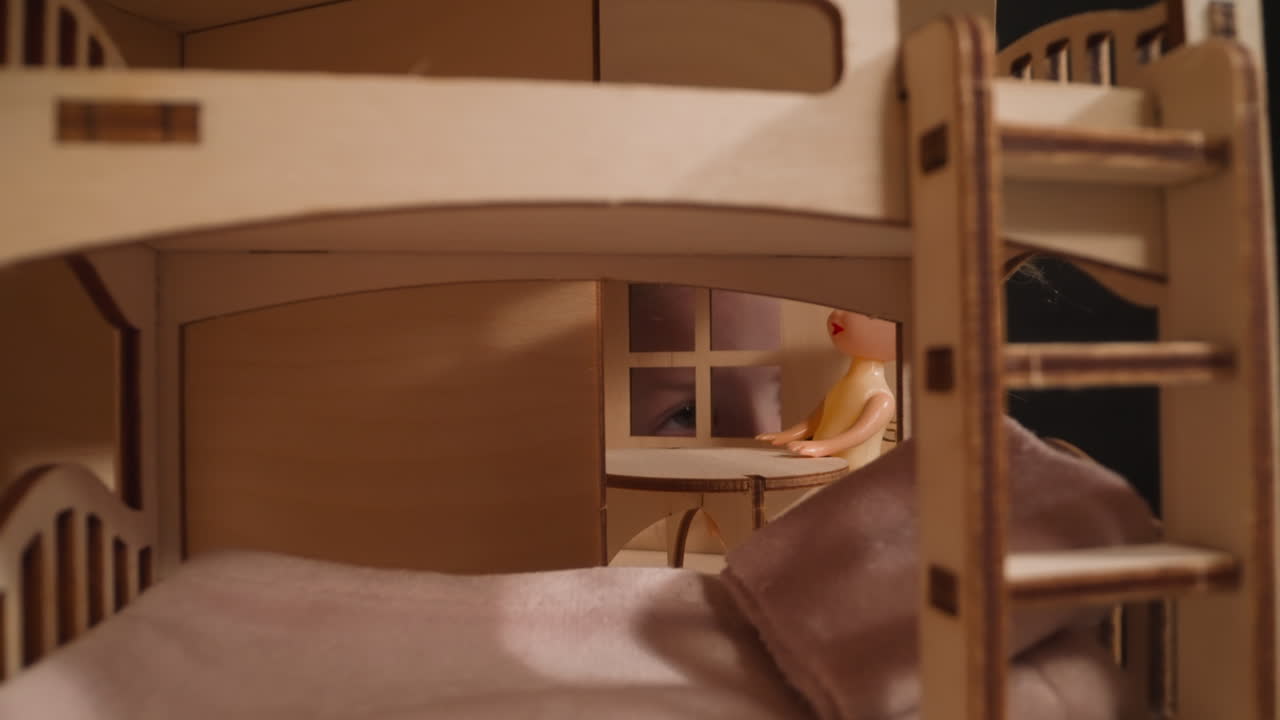 Girl with cold peeks through window of miniature dollhouse