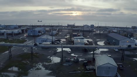 Aerial-Drone-shot-Flying-over-Flooding-Climate-Research-Center-in-the-Thawed-Permafrost-Tundra-with-Arctic-Ocean-in-Background-near-Barrow-Alaska