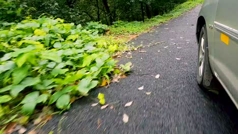 follow shot of car running around the hair pin bend in the mountains in vagamon, kerala, india