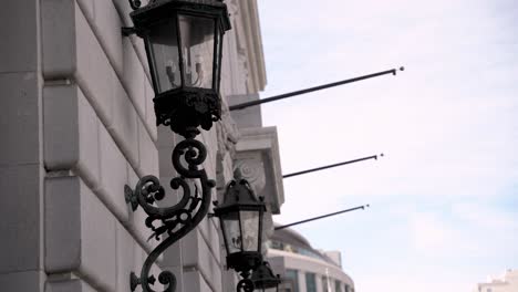 multiple lamps hanging on the side of a building