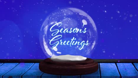 Animation-Des-Weihnachtsgrußtextes-In-Schneekugel-Und-Sternschnuppe-Auf-Blauem-Hintergrund