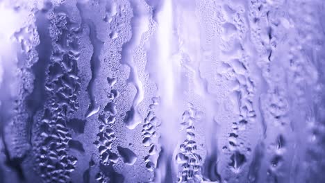 close-up view of water droplets forming condensation on glass surface