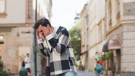 indian young man screams yell shouts from stress tension problems feels horror in city street