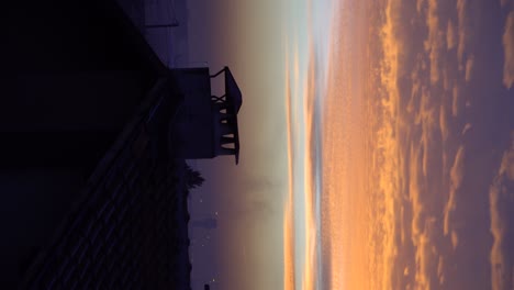 vertical footage of a beautiful cloudy sky and smoke coming out of a chimney early in the morning