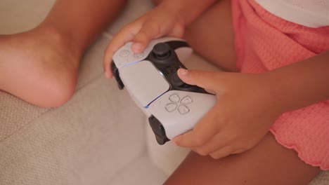 child playing with playstation 5 controller