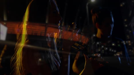 singer and guitarist duo performing under warm lights, showcasing animated sound bars for music ads