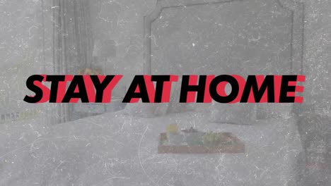 Animation of words Stay At Home flashing over an empty bedroom