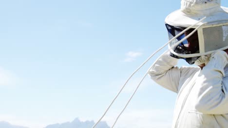 Beekeeper-wearing-protective-mask-in-apiary