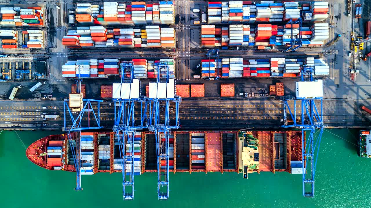 Aerial view, 4K.Time lapse Industrial port with Container port where is a part of shipping
