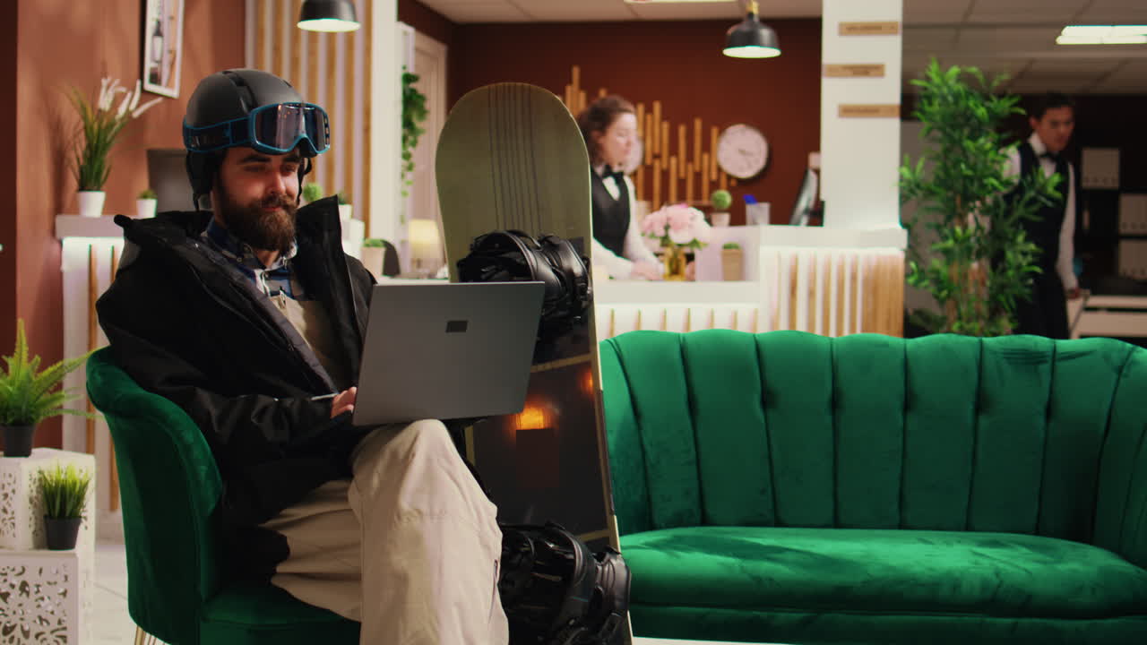 Young adult checks website on laptop