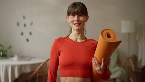 woman holding yoga mat
